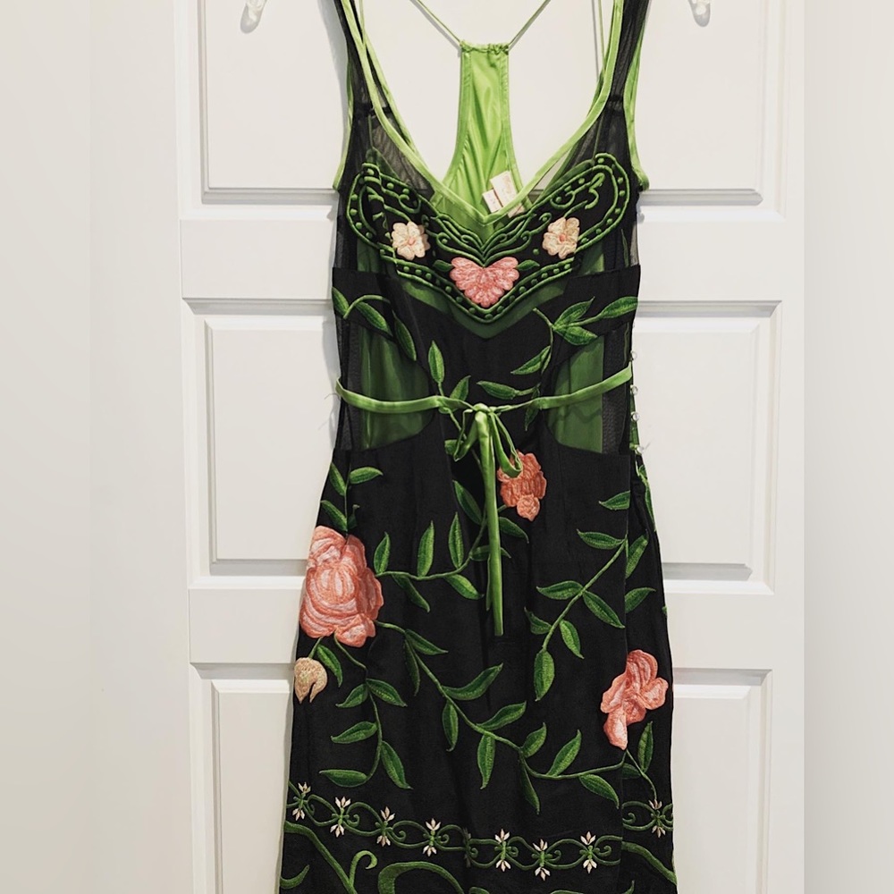 Lined dress with exceptional quality. Embroidery is unique to the dress.